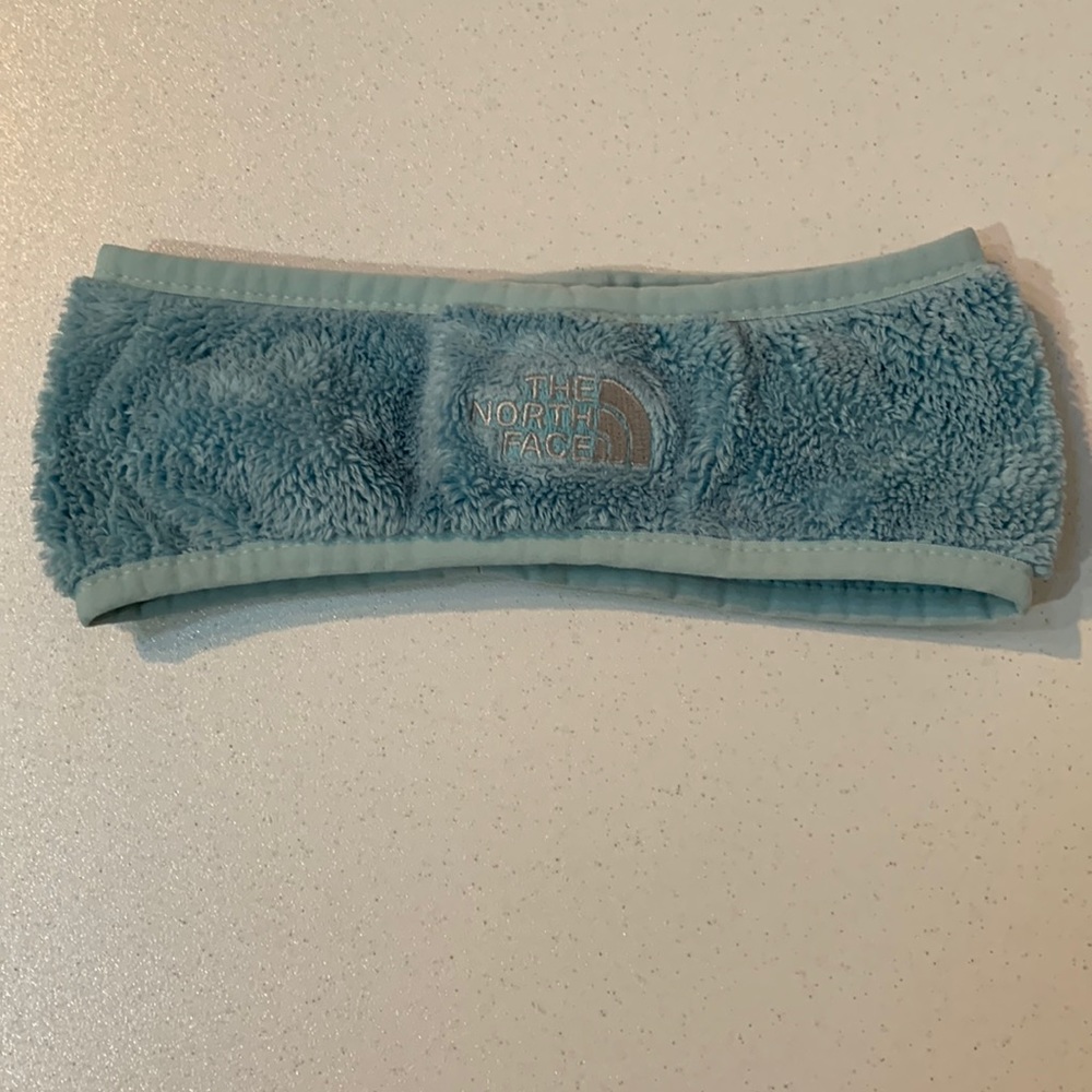 The North Face ear band. Aqua blue fleece. Size youth medium. Gently used.